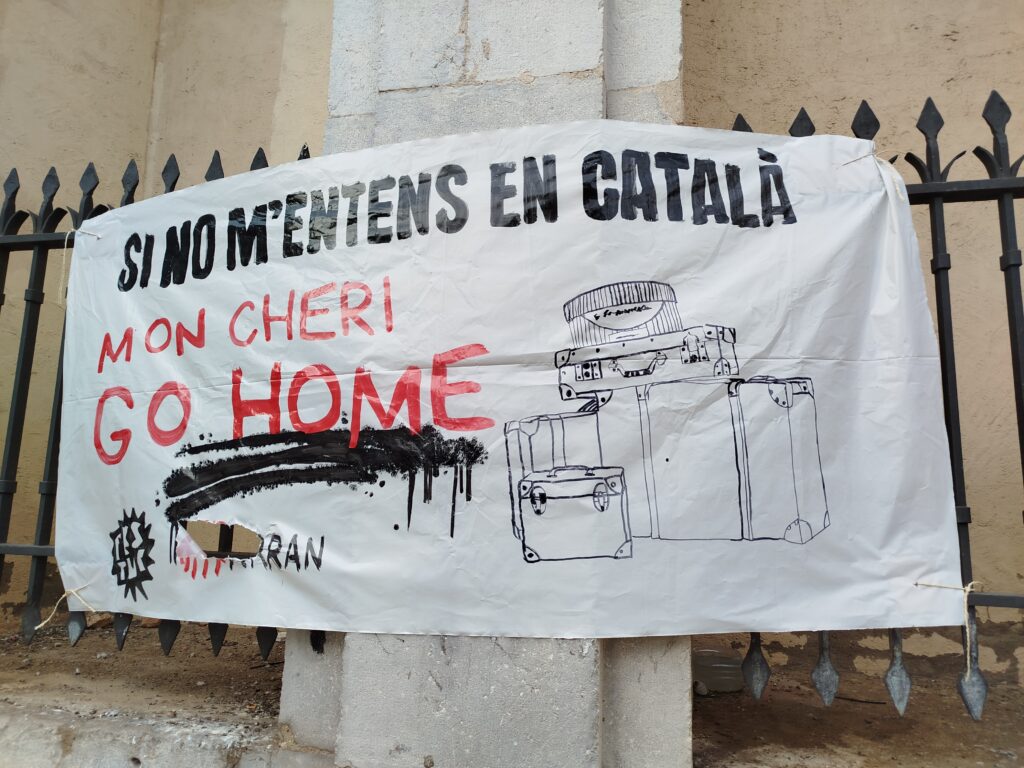 Imagen de un cartel que pone en catalán: SI no me entiendes en catalán, mon cheri, go home. Es importante elegir bien el idioma de tu proyecto en Barcelona